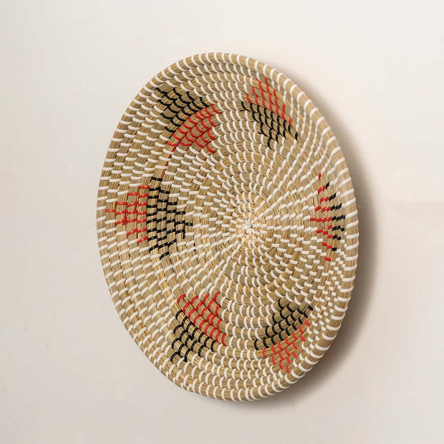 Side angle of round basket wall decor highlighting woven texture thickness and handcrafted details.
