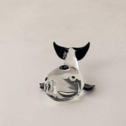 Handcrafted clear glass dolphin figurine with sleek finish ideal for tabletop display and marine themed decor.