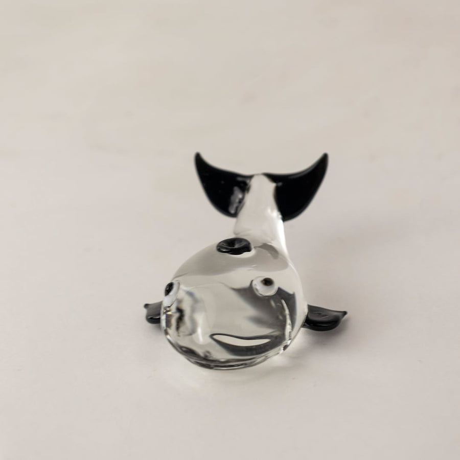 Handcrafted clear glass dolphin figurine with sleek finish ideal for tabletop display and marine themed decor.