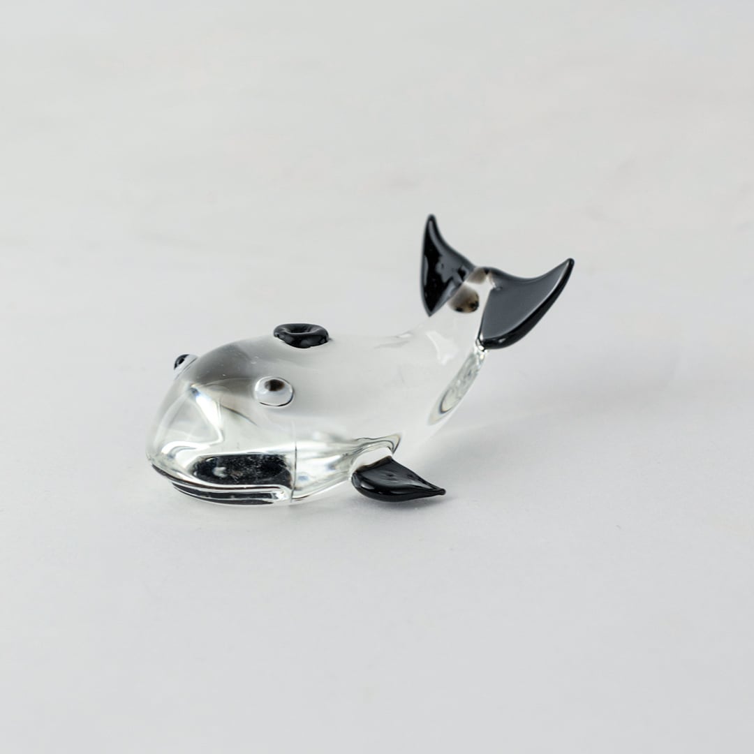 Transparent dolphin figurine made of fine glass with black fins perfect for living room or office tabletop decor.