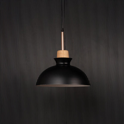 Black dome pendant ceiling light with wooden accent switched off on back background for modern dining room cafe and kitchen lighting.