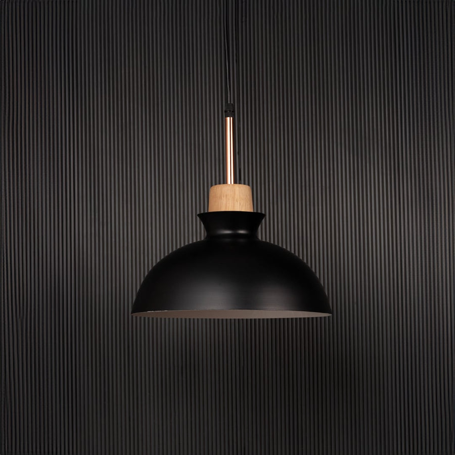 Black dome pendant ceiling light with wooden accent switched off on back background for modern dining room cafe and kitchen lighting.
