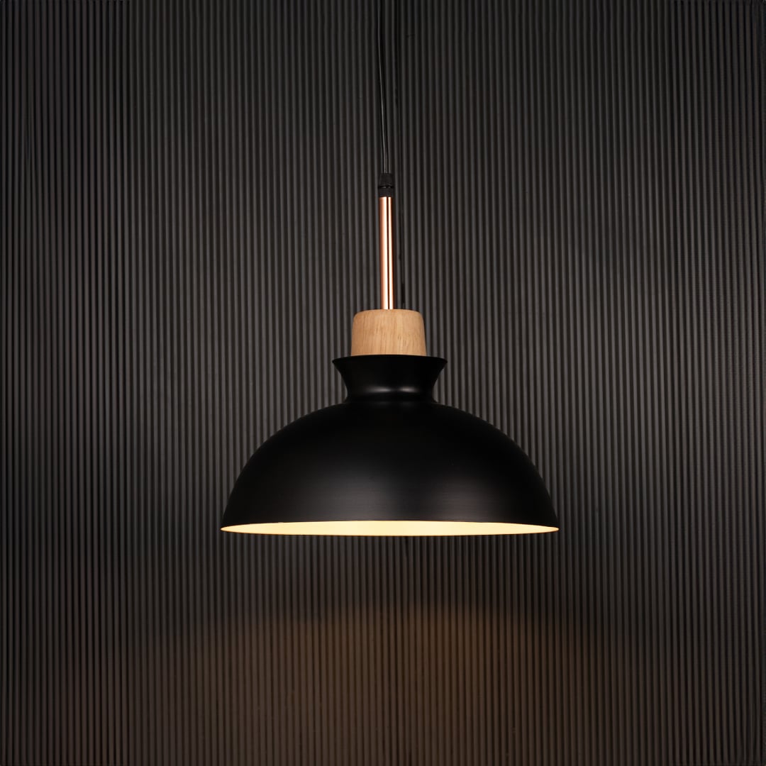 Black dome pendant ceiling light with wood accent illuminated on back background for dining room cafe and modern interior lighting.