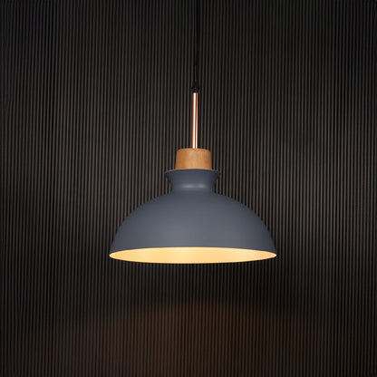 Grey dome pendant ceiling light with wooden accent illuminated on back background for dining room cafe and modern interior decor lighting.