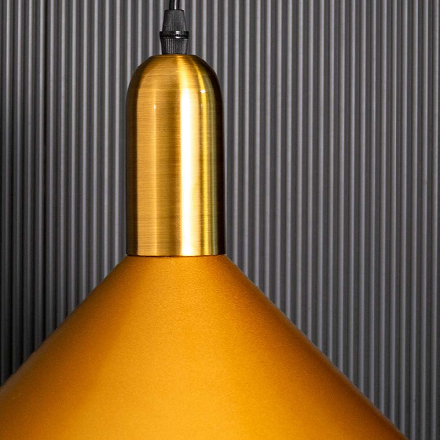 A detailed close view of the gold cone pendant light highlighting its polished metal finish and refined geometric shape suited for stylish decor.