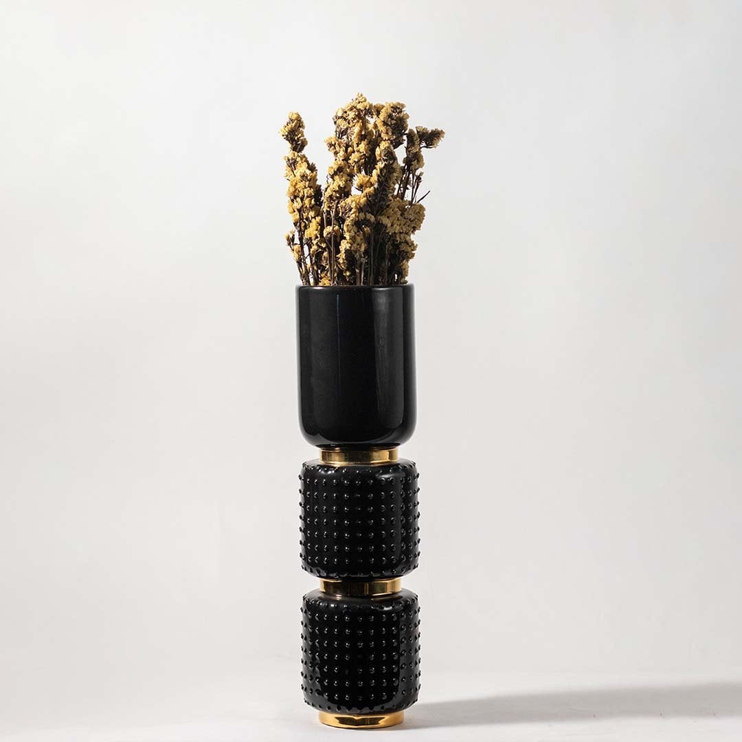 Natural yellow dried flowers held in hand against a soft room setting adding warm rustic texture to modern home decor.