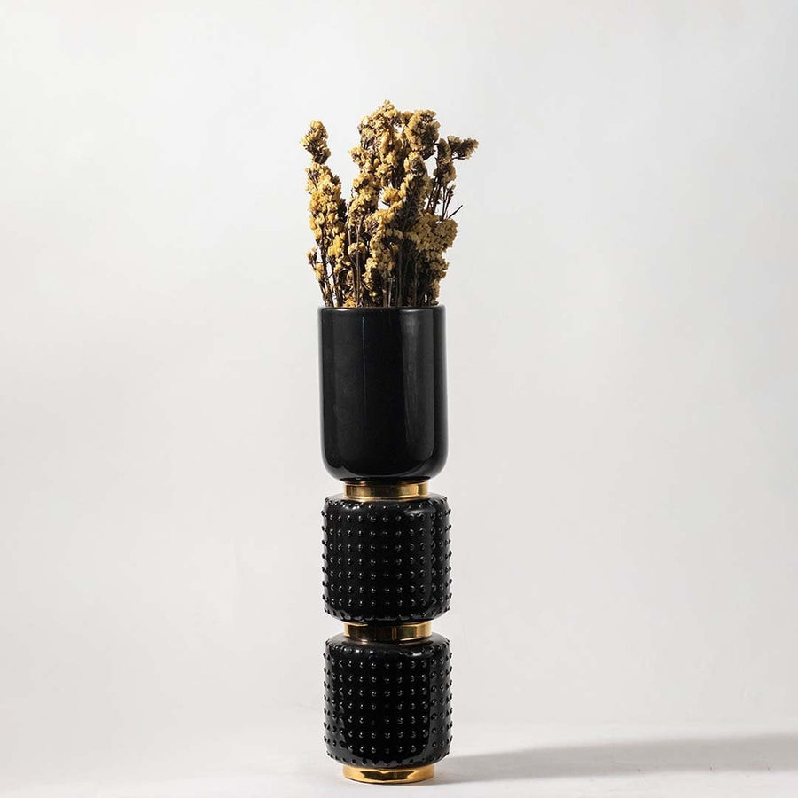 Natural yellow dried flowers held in hand against a soft room setting adding warm rustic texture to modern home decor.