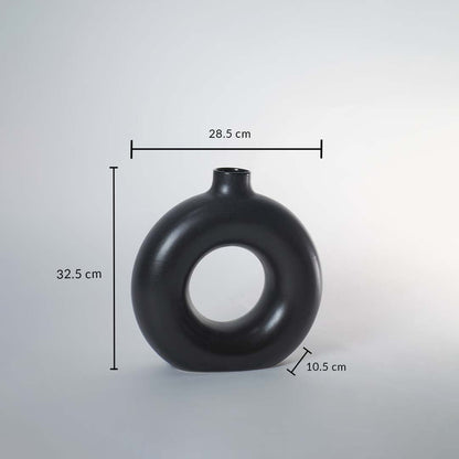 Black ceramic donut vase with matte finish measuring 32.5 cm height 28.5 cm width and 10.5 cm depth for elegant decor.