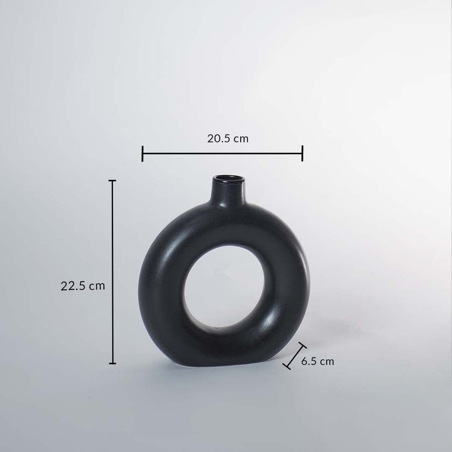 Black ceramic donut vase with matte finish measuring 22.5 cm height 20.5 cm width and 6.5 cm depth for stylish decor.