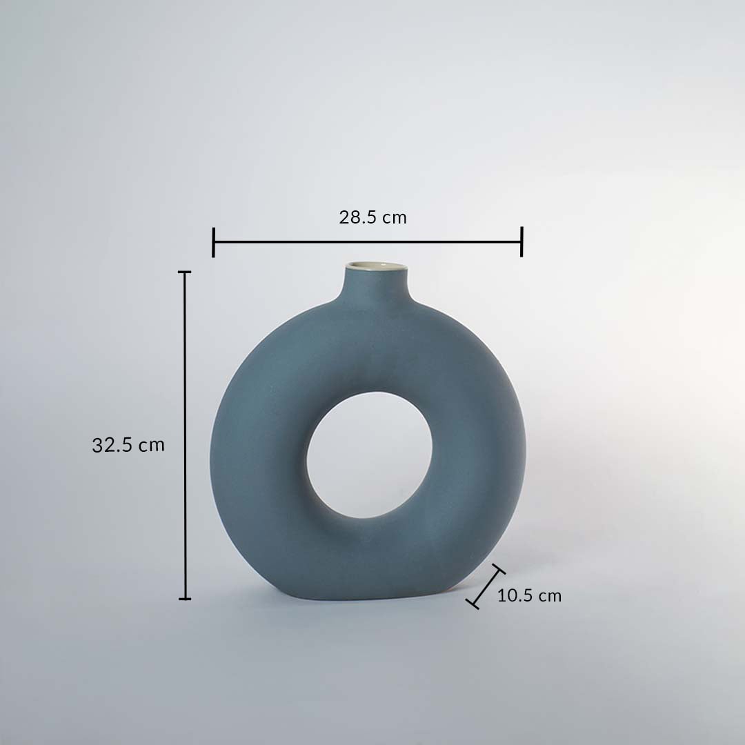 Green ceramic donut vase with matte finish measuring 32.5 cm height 28.5 cm width and 10.5 cm depth for stylish decor.
