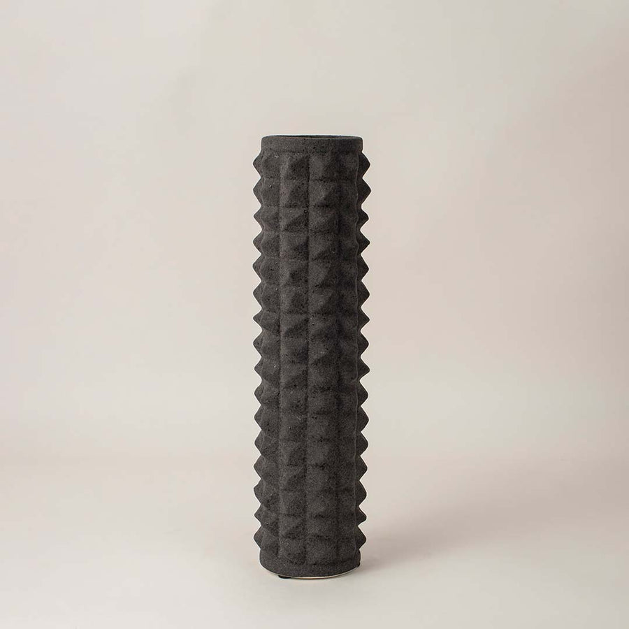 Elegant black ceramic vase with raised diamond texture displayed on white background for contemporary interior decor.