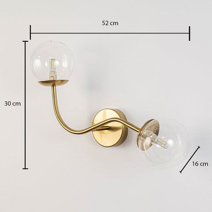 Clear glass globe double arm wall lamp with gold base dimension 30 cm height 52 cm width 16 cm depth for living room decor.