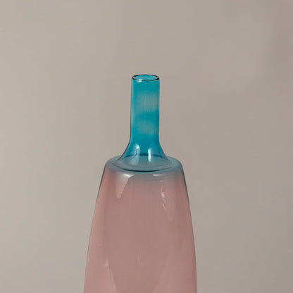 Closeup of handcrafted pink and blue glass vase showing sleek gradient finish and artistic smooth texture.