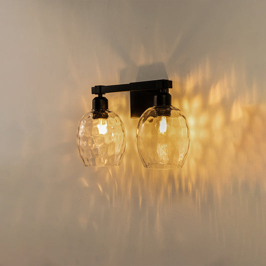 Modern black metal wall lights with textured glass shades for stylish bedroom and luxury decor spaces.

