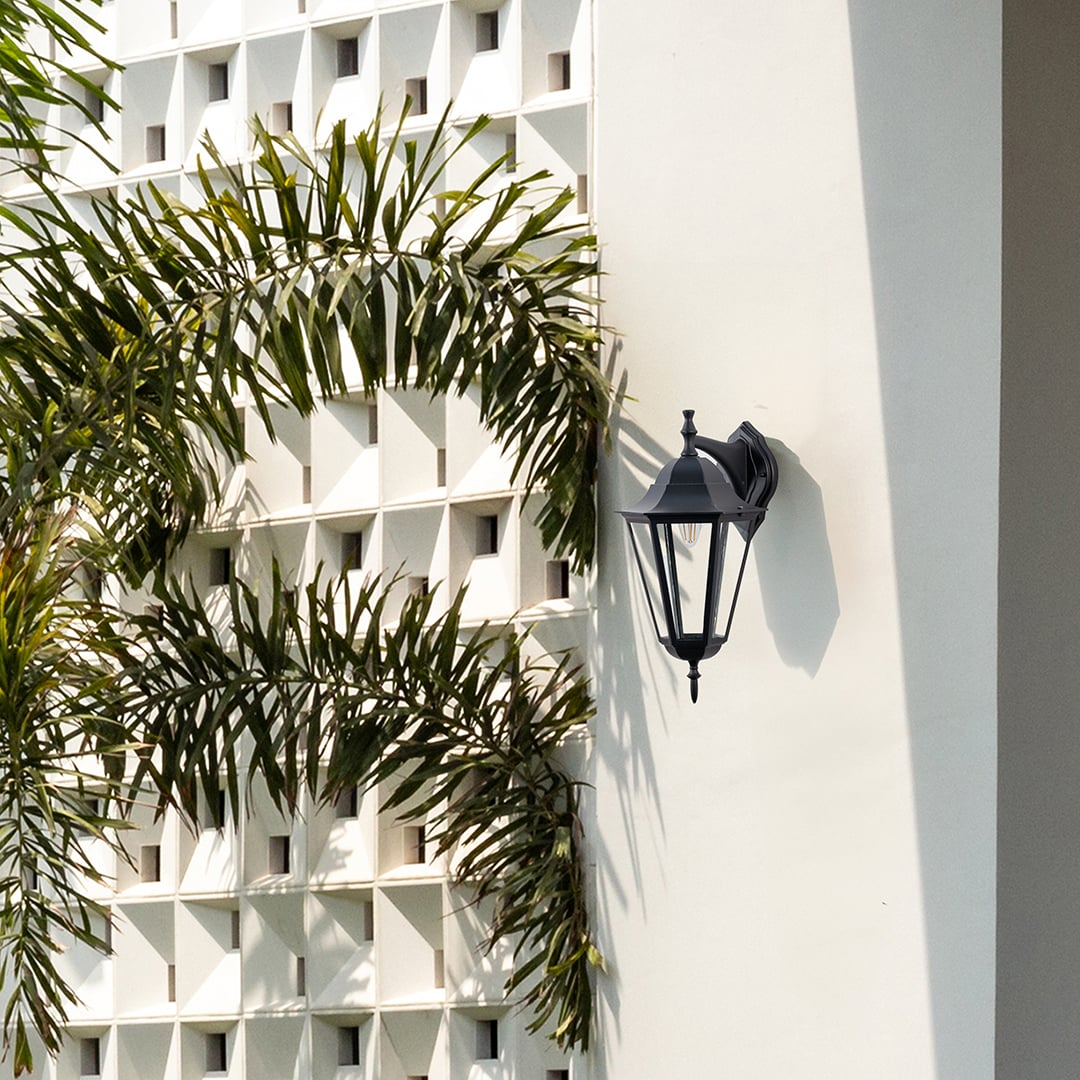 Elegant outdoor wall lantern in black finish illuminating exterior walls with timeless charm and warm ambient glow.