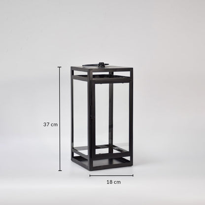 Black metal lantern showing 37 cm height and 18 cm width dimensions suitable for tabletop floor or porch decorative lighting placement.