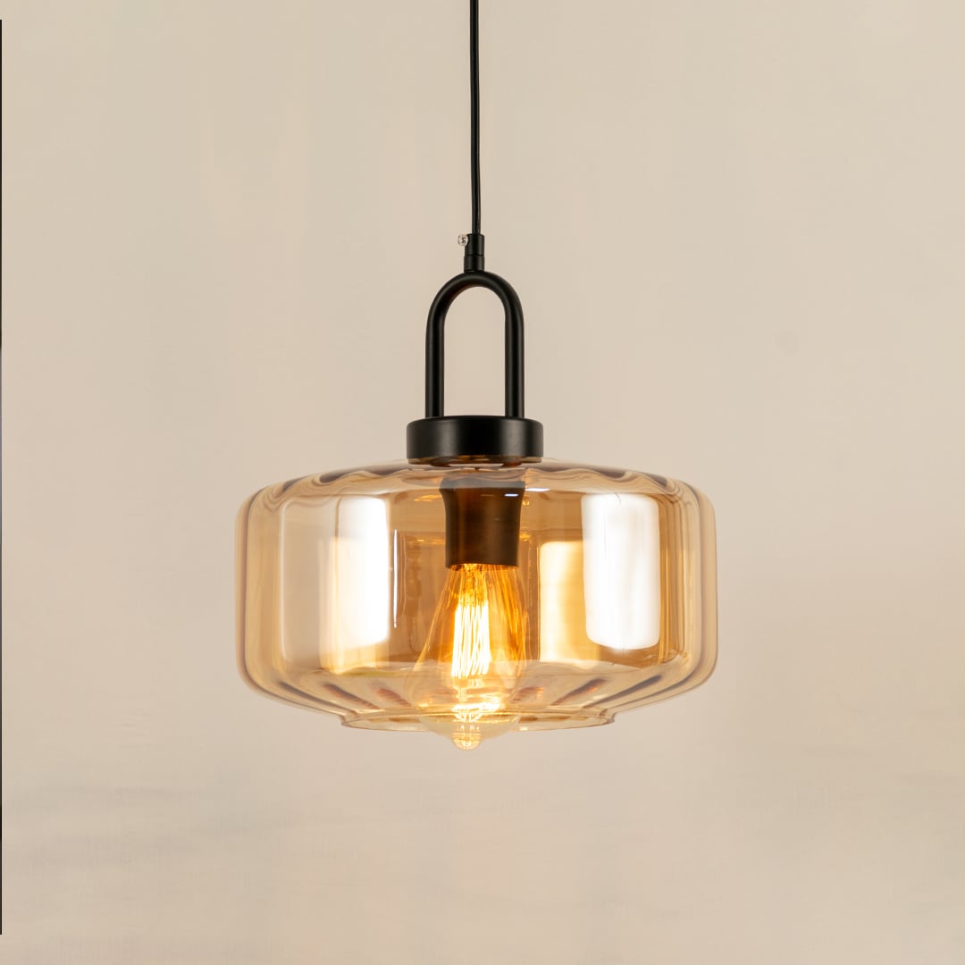 Amber glass pendant light with a faceted shade glowing warmly and creating a soft modern accent that enhances the room with a subtle contemporary decorative presence.