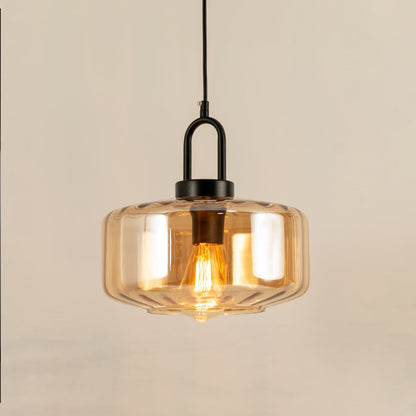 Amber glass pendant light with a faceted shade glowing warmly and creating a soft modern accent that enhances the room with a subtle contemporary decorative presence.