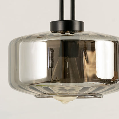 Smoky grey glass pendant light with warm LED illumination perfect for modern interior design and dining room lighting offering a sleek contemporary ceiling light accent.