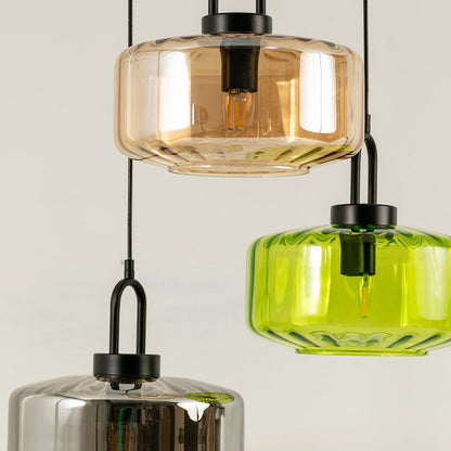 Amber smoke and green glass pendant lights creating vibrant ambient lighting in a stylish contemporary interior setting.