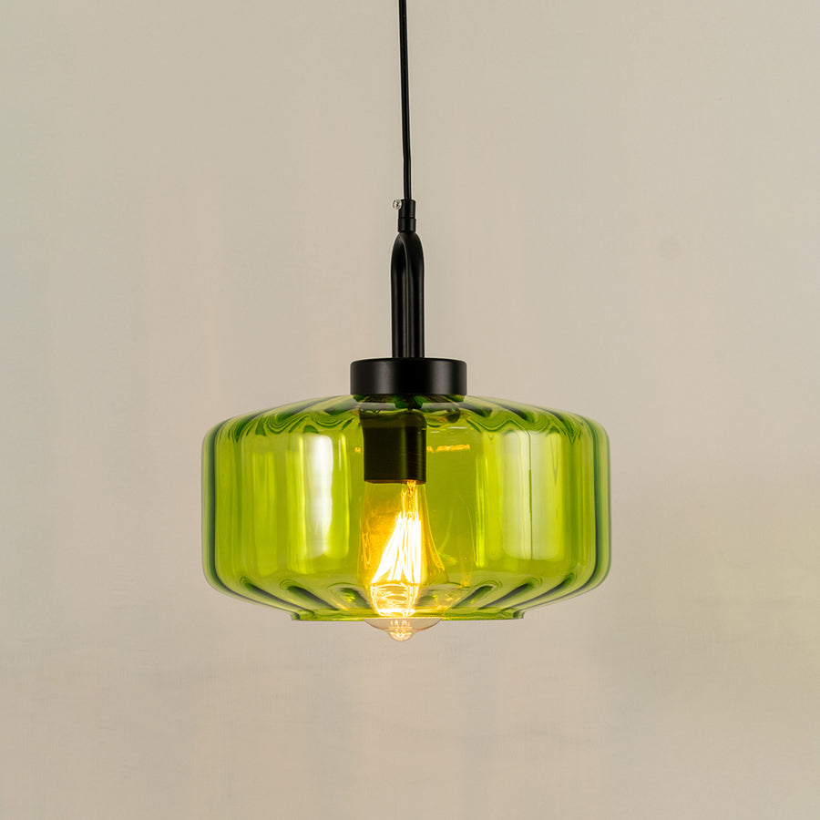 Elegant green glass pendant light with black metal finish for stylish kitchen and dining room decor styling.
