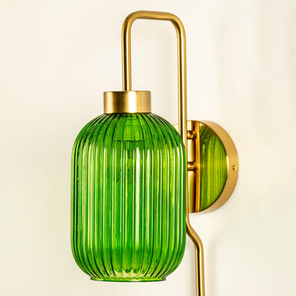Closeup view of green ribbed glass wall sconce showing its detailed vertical texture and long smooth metal rod ideal for refined modern interior home decor lighting.
