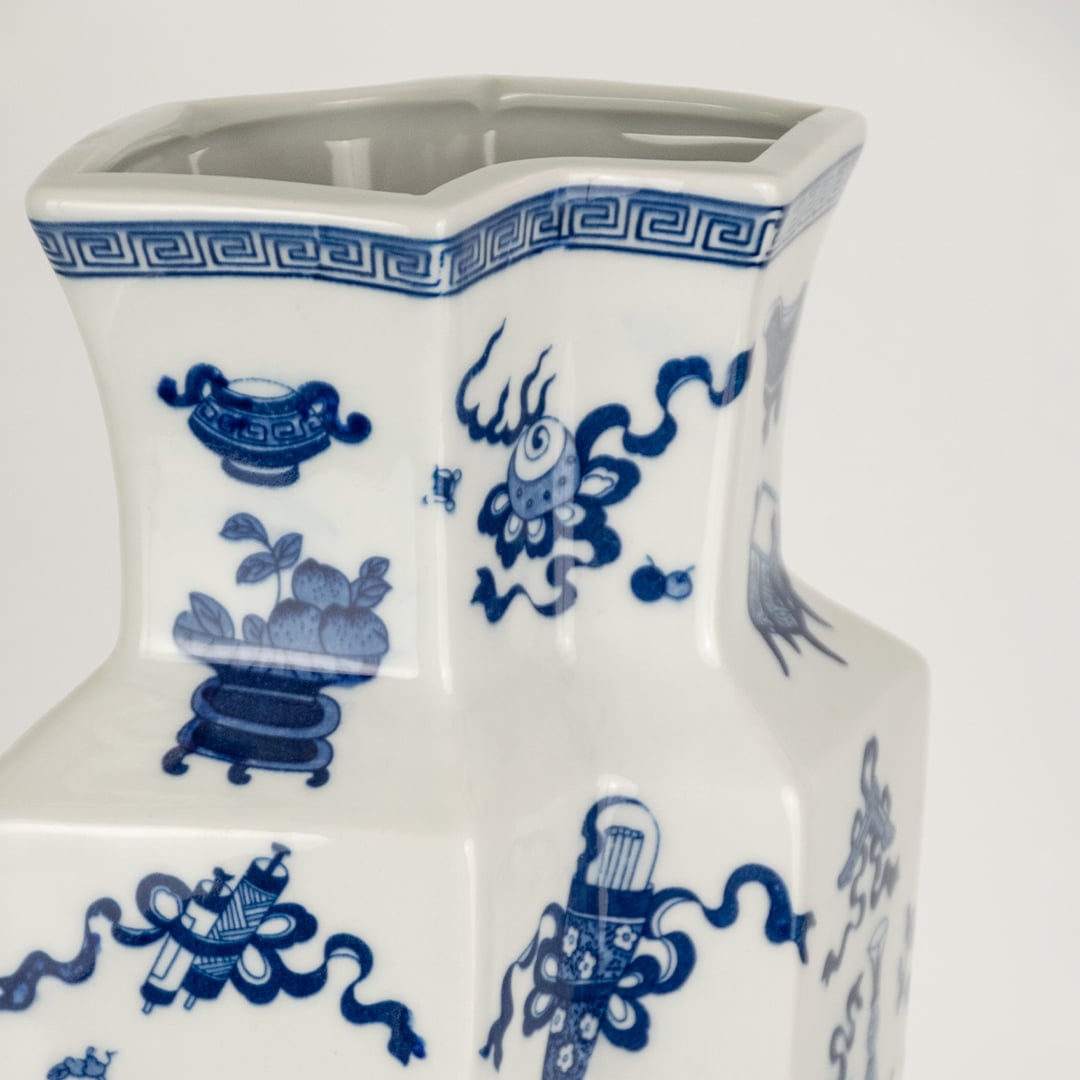 Closeup of blue and white ceramic decorative vase with floral artwork showcasing premium craftsmanship and elegant styling.