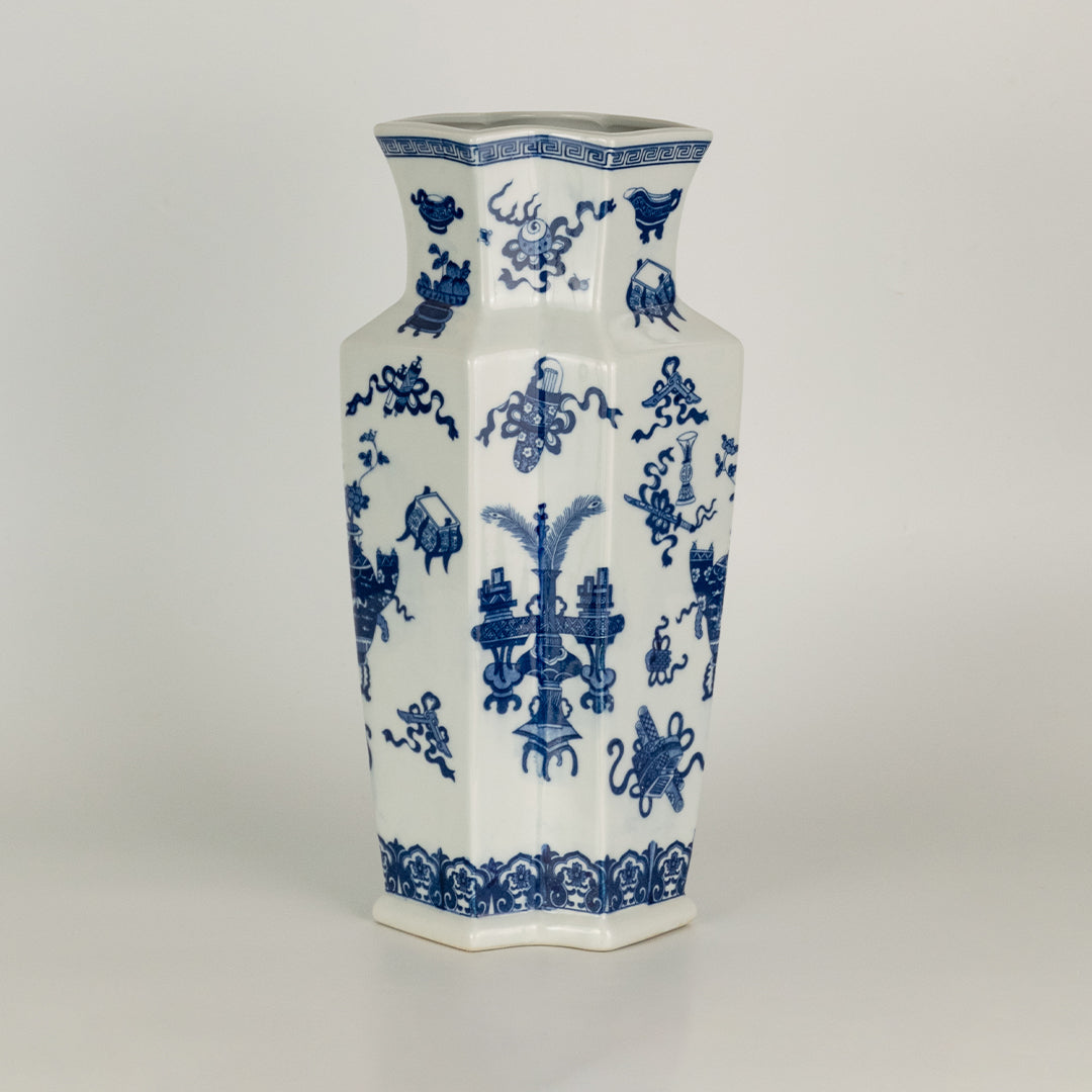 Blue and white ceramic vase with floral pattern design perfect for elegant table or shelf decor placement in modern home interior.