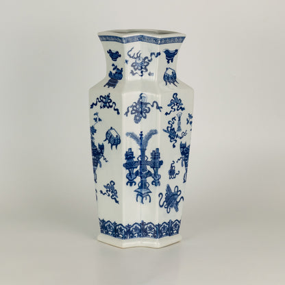 Blue and white ceramic vase with floral pattern design perfect for elegant table or shelf decor placement in modern home interior.