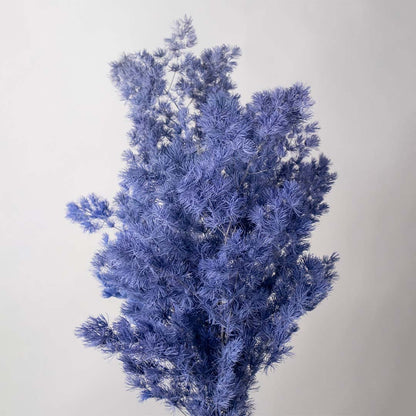 Closeup of blue preserved foliage bouquet natural dried stems lifestyle decor floral arrangement background.
