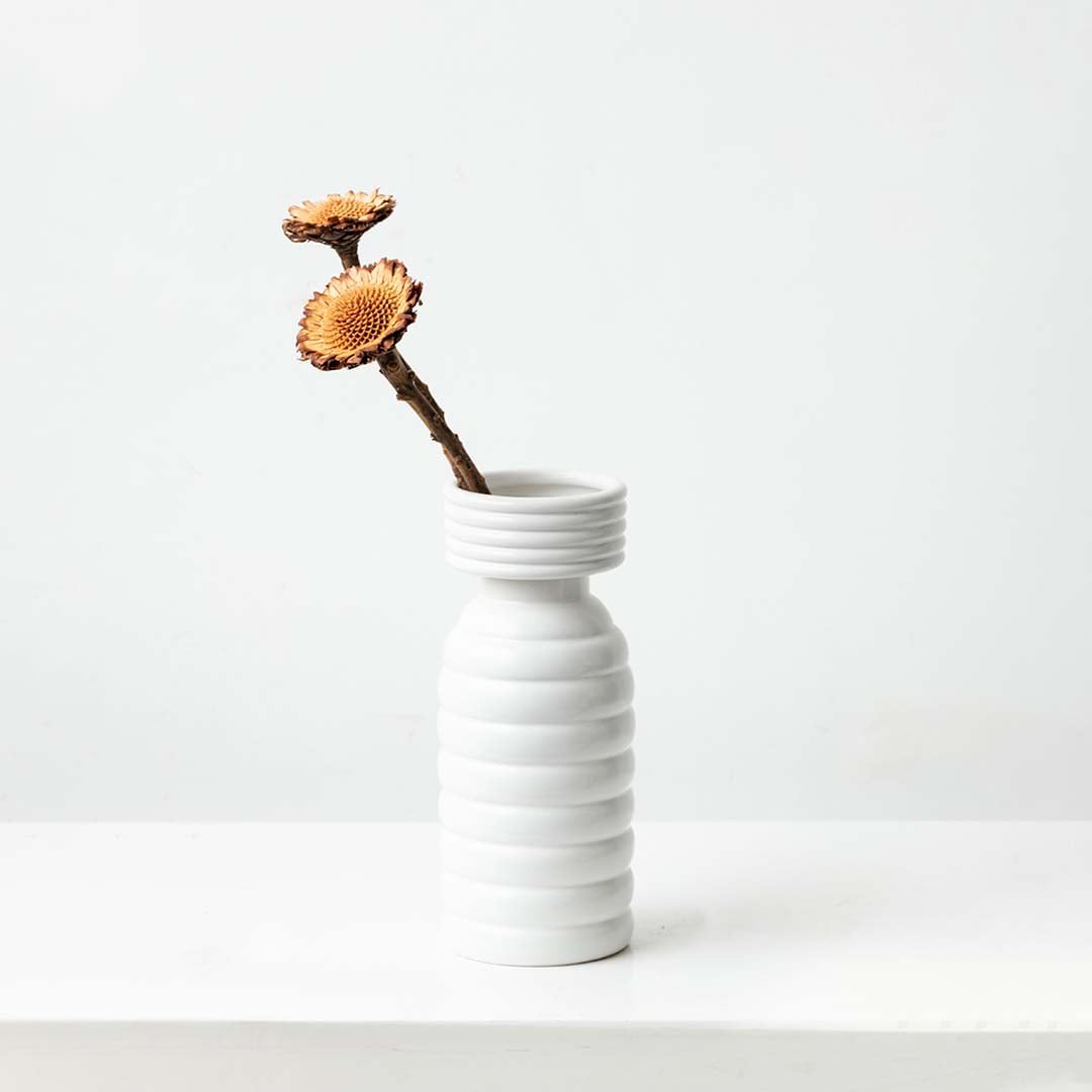 Natural dried wooden flower stem in warm brown tones styled for rustic home decor display adding organic texture and charm.