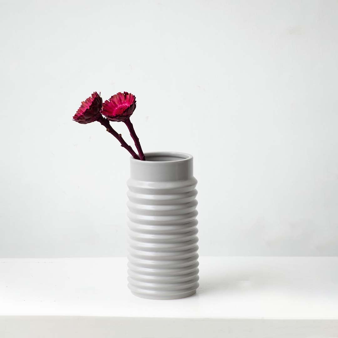 Vibrant dried wooden flower stem in deep magenta styled for modern home decor adding natural texture and rich color.