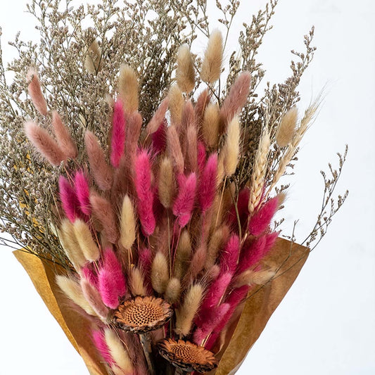 Preserved dried flower bouquet with pink bunny tail grass and natural fillers styled for home decor display.