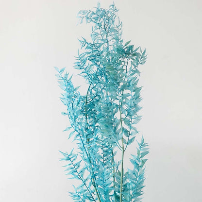 Closeup of turquoise preserved foliage stem with natural style leaves perfect for DIY vase decoration and home interior design.