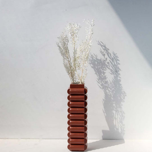 Soft ivory dried foliage stem styled in a calm modern room adding airy natural texture to contemporary home decor.