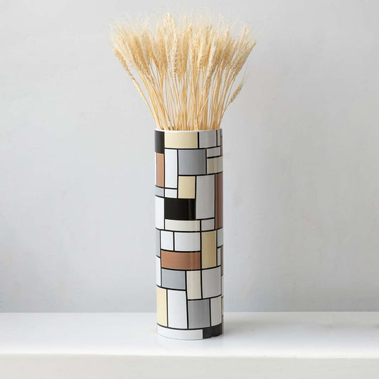 Dried wheat grass arranged in a tall mosaic vase perfect for farmhouse décor rustic styling and natural earthy home interior decoration.