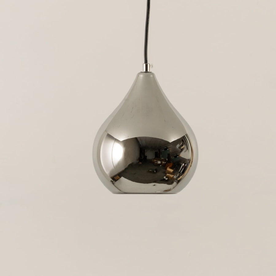 Chrome pendant light with its reflective silver body displayed with light off on a soft white background for product detailing.