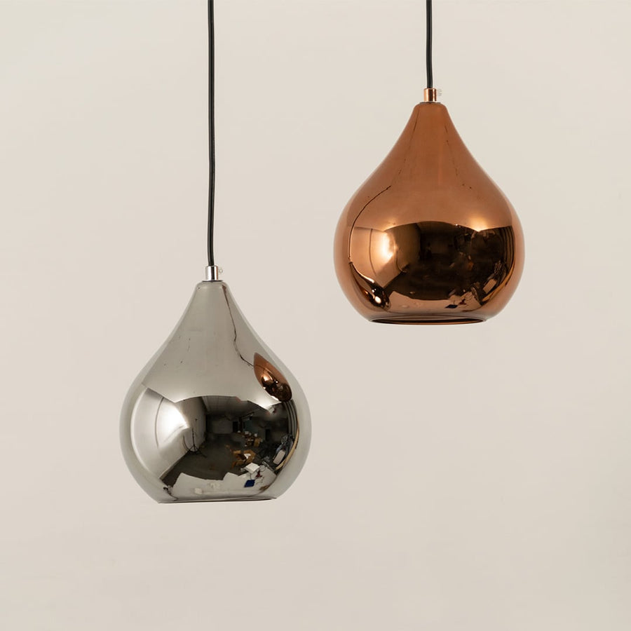 Set of copper metal pendant lights with glossy finish arranged together for coordinated modern ceiling lighting decor.