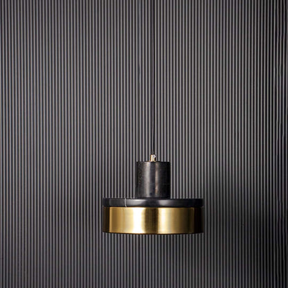 Modern pendant light with black metal shade and gold accent shown unlit on black background for bold contemporary ceiling decor.