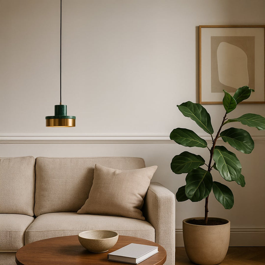 Green marble and gold pendant light styled above beige sofa with indoor plant in modern living room interior for luxury decor.