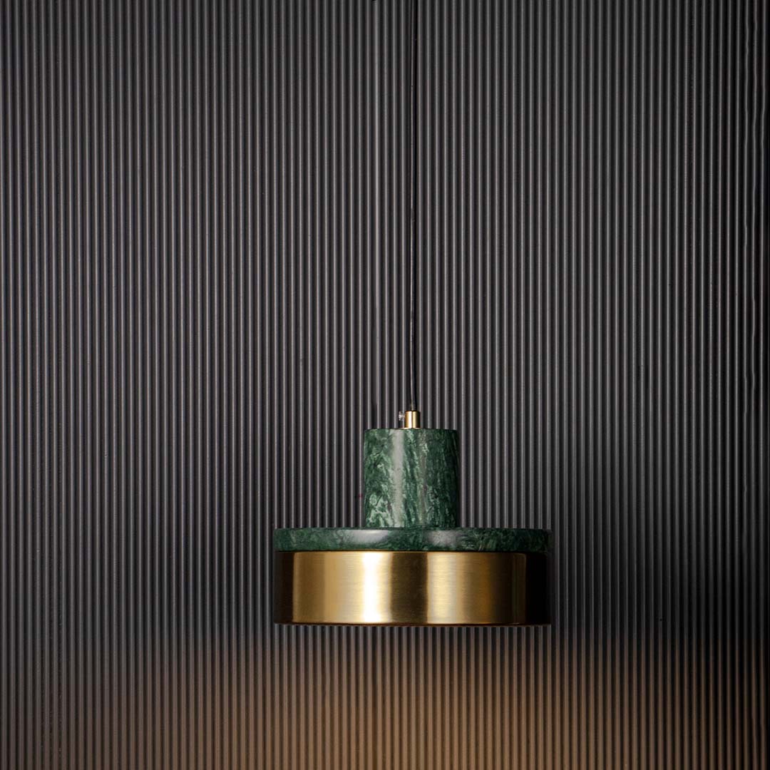 Luxury pendant lamp with green marble and golden base shade glowing warmly displayed on black background for modern decor.