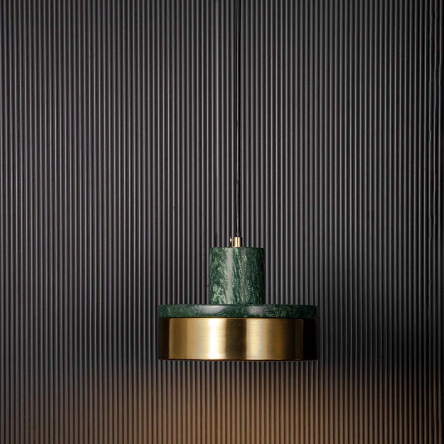 Luxury pendant lamp with green marble and golden base shade glowing warmly displayed on black background for modern decor.