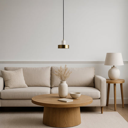 White marble and gold pendant light styled above beige sofa with wooden table in modern living room interior for luxury decor.