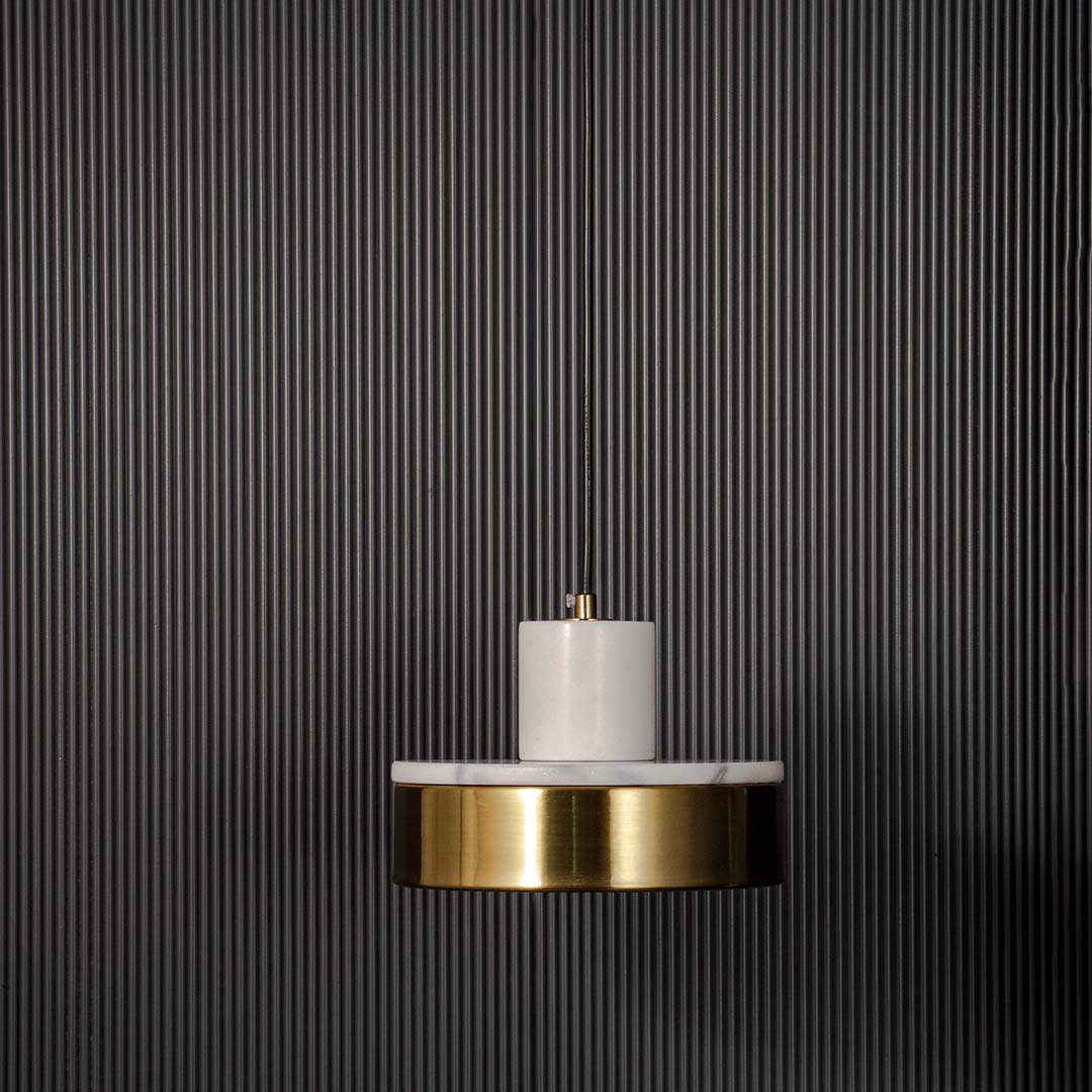 Elegant pendant light with white marble detail and gold base shade displayed off on black background for modern interiors.