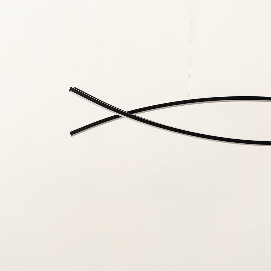 A sleek black linear chandelier with two intersecting curved bars displayed on a clean white backdrop with the light off offering minimal refined modern décor.