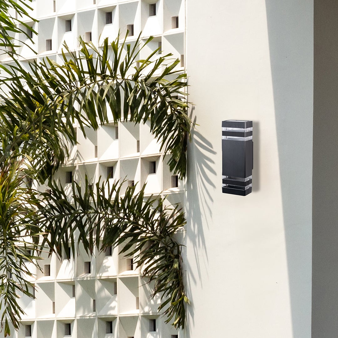 Elegant black wall light adding ambient glow and modern character to minimal living spaces.