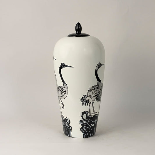 Side angle view of round ceramic jar showing elegant floral branches and butterfly painting with gold detailing.
