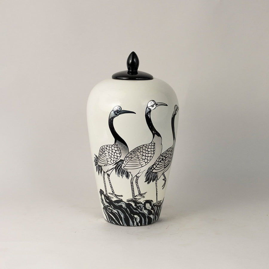 Glossy white ceramic jar with black crane motif and smooth finish ideal for modern and traditional home styling.