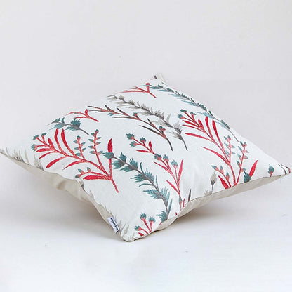 Soft cotton cushion cover with coral and teal botanical design shown at an angle creating a lively nature inspired décor accent with a breathable gentle and skin friendly fabric.