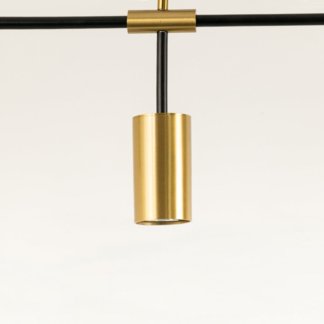 Close view of gold light fixtures on black frame showing brushed metallic finish and fine craftsmanship with elegant detailing.